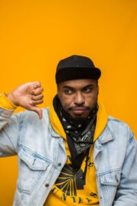 stylish black man showing thumb down
